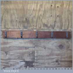 Mahogany 40” (1m) coat rail with five cast steel hangers in good condition.