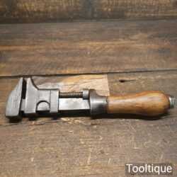 T22664 - Vintage automotive adjustable spanner wrench with wooden handle, in fair used condition.